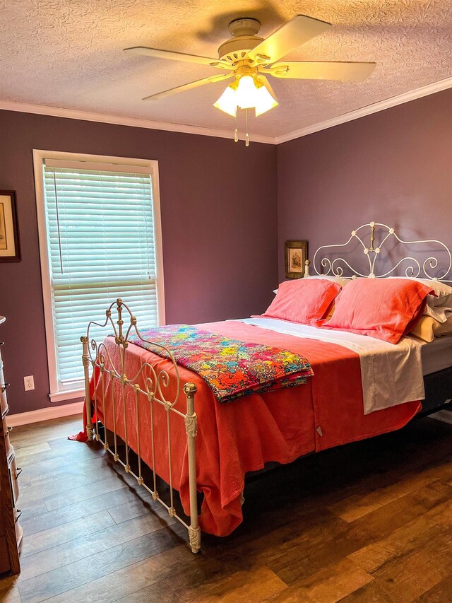 bedroom featuring wood-type flooring, a textured ceiling, ceiling fan, and crown molding