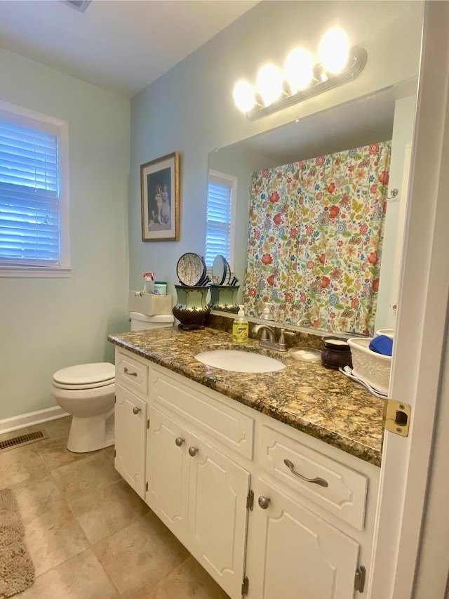 bathroom featuring vanity and toilet