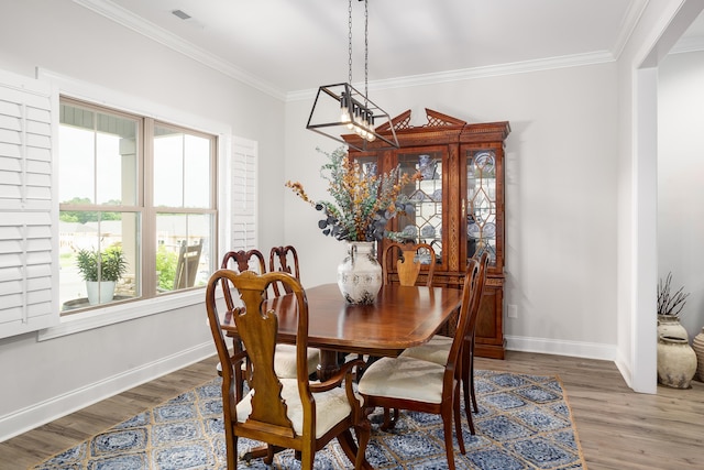  - dining space featuring wood finished floors and ornamental molding