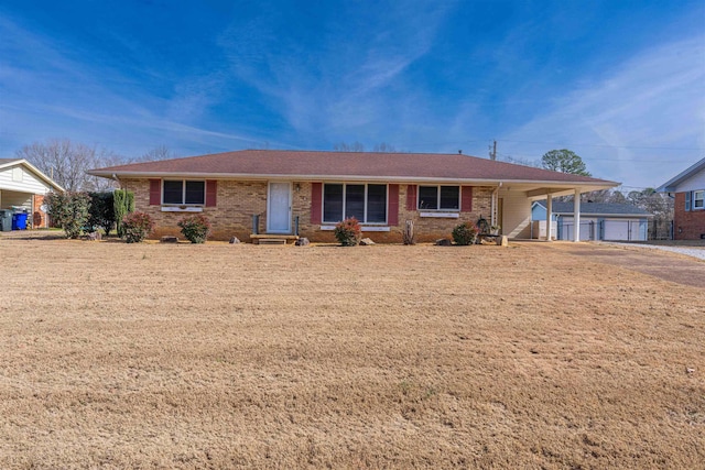 single story home featuring a garage, an outdoor structure, and a carport