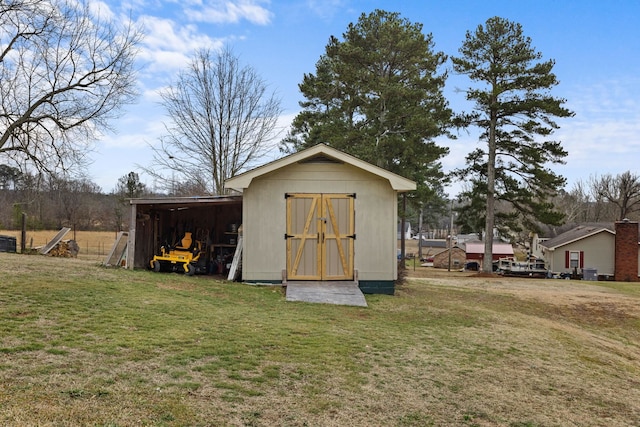 view of outbuilding featuring a yard