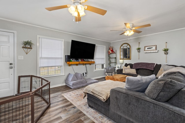 living room featuring hardwood / wood-style flooring, ornamental molding, and ceiling fan