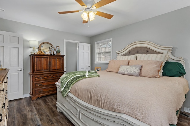 bedroom with dark hardwood / wood-style flooring and ceiling fan