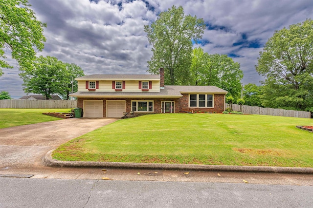 - view of front of property with a garage, driveway, a chimney, and brick siding