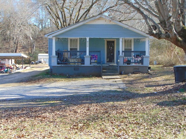 bungalow-style house featuring a carport and covered porch