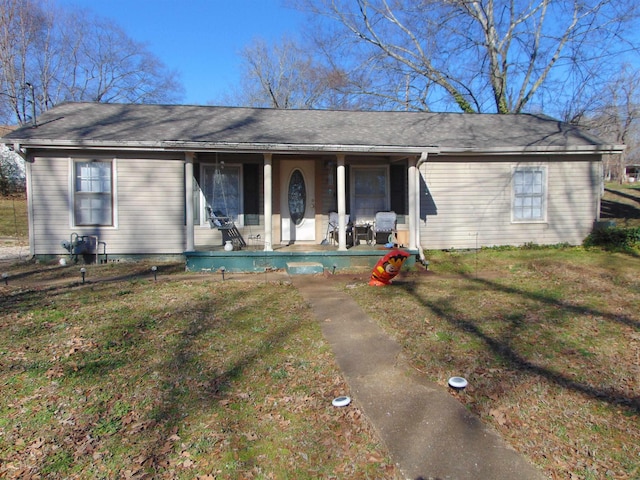 ranch-style house with a porch and a front lawn