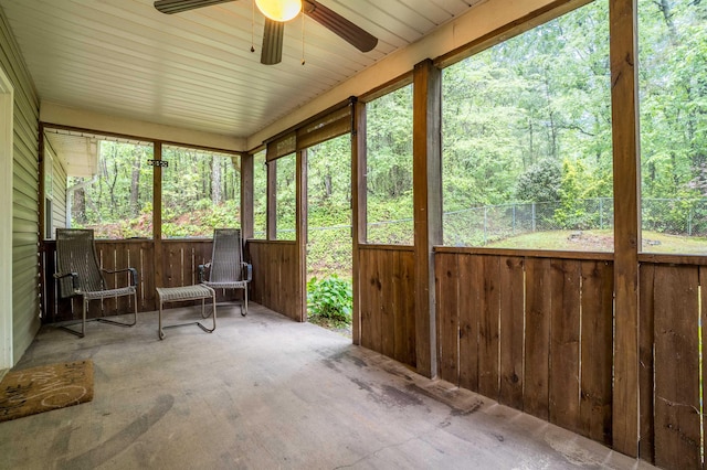  - sunroom / solarium featuring a forest view and a ceiling fan