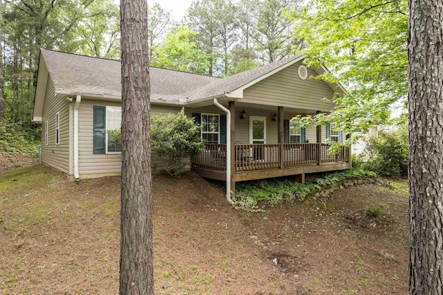  - exterior space featuring roof with shingles