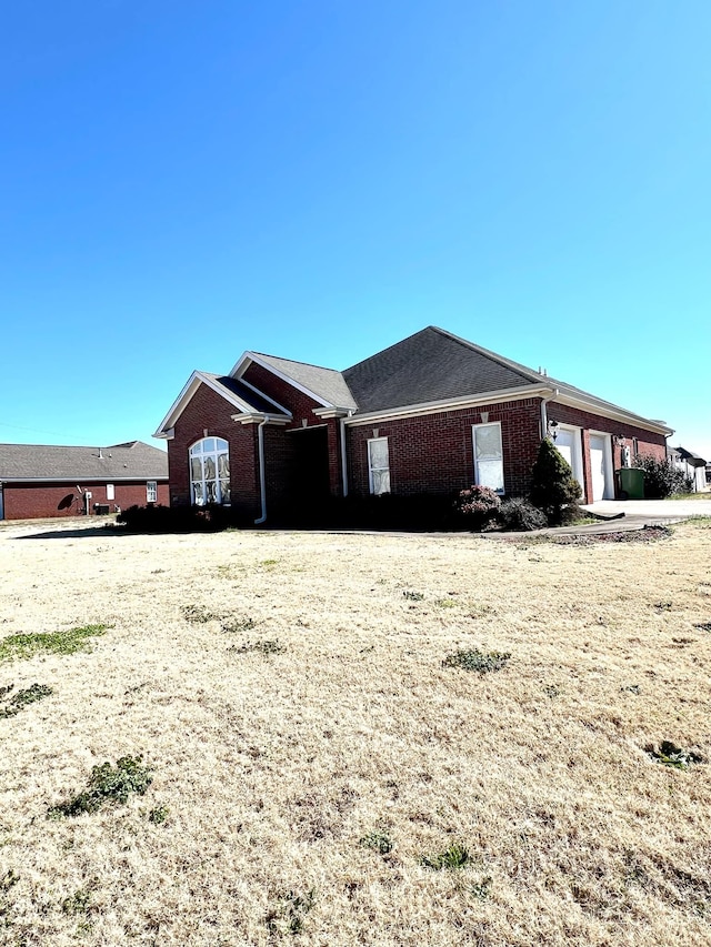 view of front of home with brick siding and an attached garage