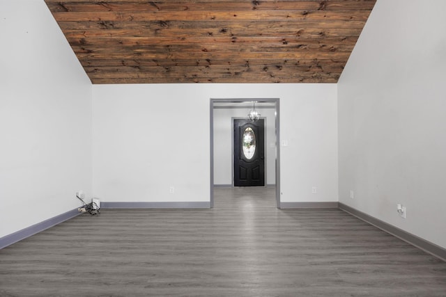 interior space with wood ceiling, vaulted ceiling, wood finished floors, and baseboards