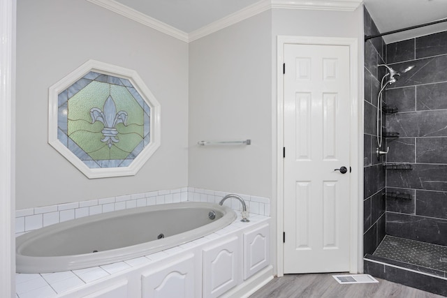 full bath featuring a tile shower, ornamental molding, wood finished floors, and a whirlpool tub