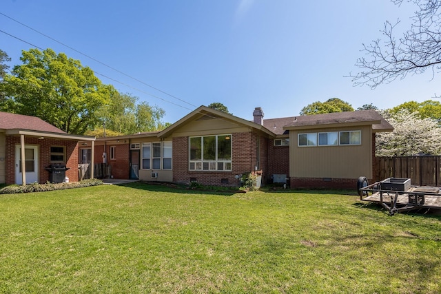  - rear view of property featuring a yard, crawl space, fence, and a chimney