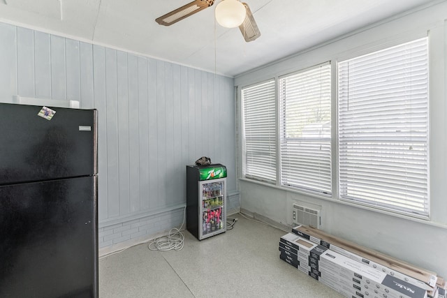  - miscellaneous room featuring wood walls and ceiling fan