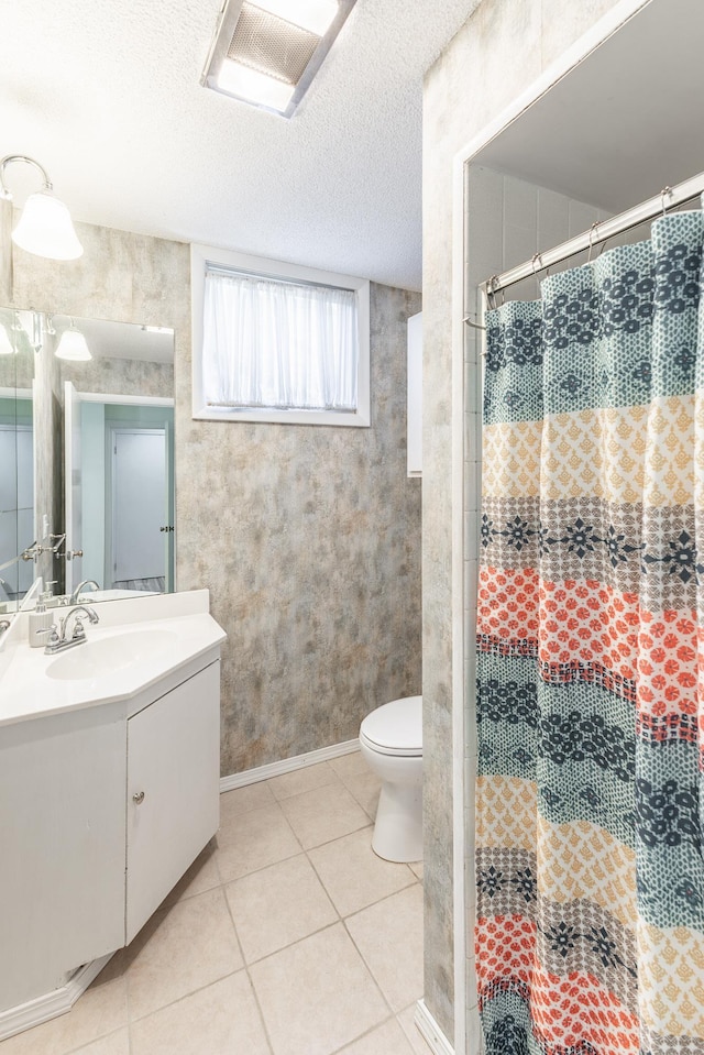  - bathroom with toilet, a shower with curtain, tile patterned flooring, and vanity