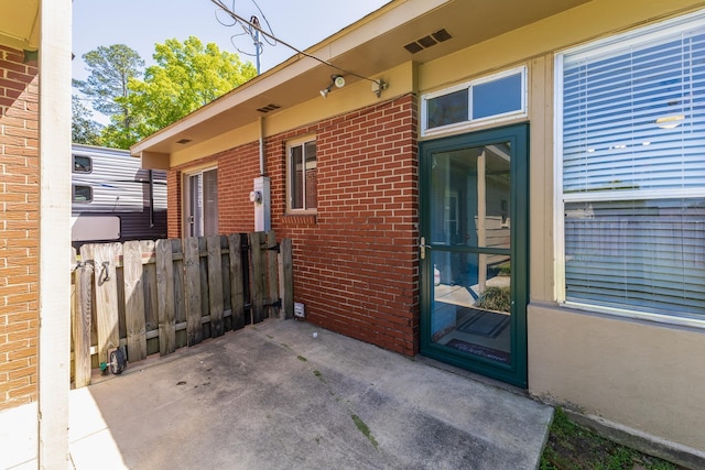  - exterior space with visible vents and fence