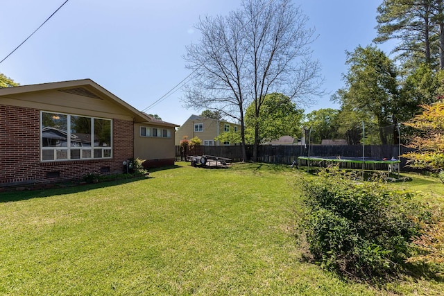 - view of yard featuring a trampoline and fence