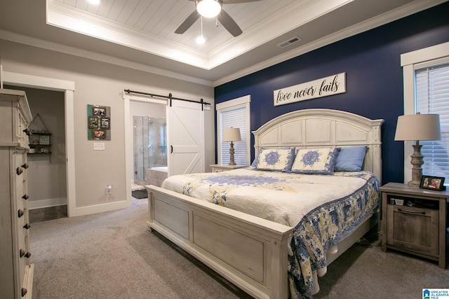 - bedroom with a raised ceiling, a barn door, light colored carpet, crown molding, and a ceiling fan