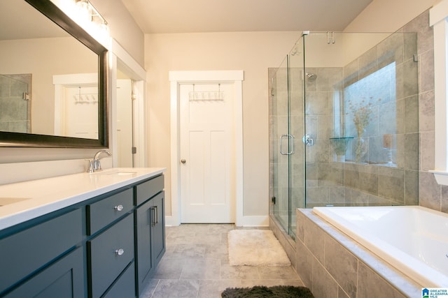  - full bath with double vanity, a garden tub, and a stall shower