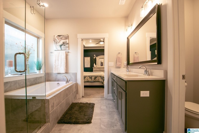  - bathroom featuring double vanity, a garden tub, a ceiling fan, ensuite bathroom, and a shower with shower door