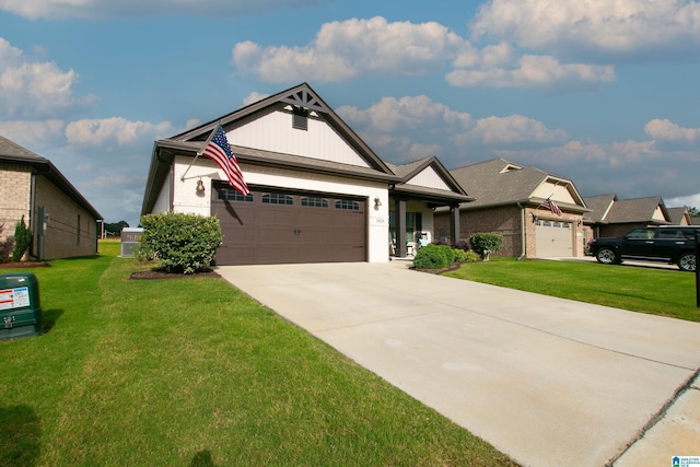  - view of front of home featuring an attached garage, a front lawn, and driveway