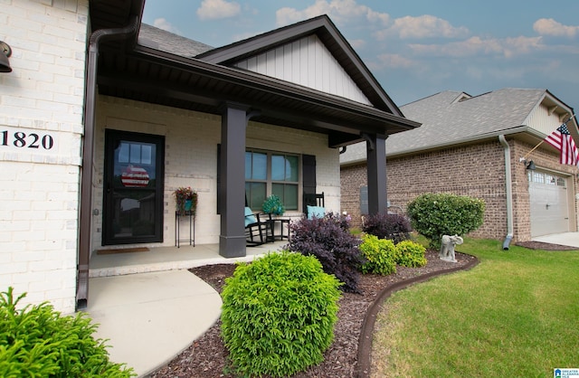  - doorway to property with covered porch, brick siding, and roof with shingles