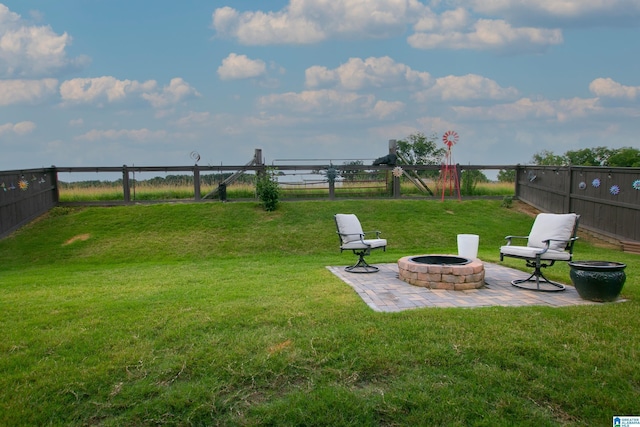  - fenced backyard featuring a fire pit and a patio