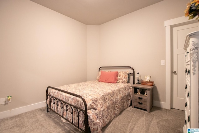  - carpeted bedroom with baseboards