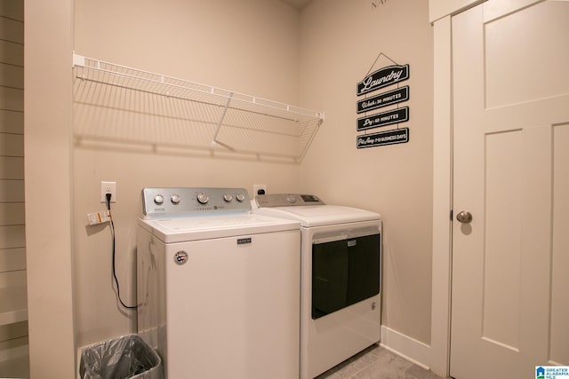  - washroom with washing machine and clothes dryer and baseboards