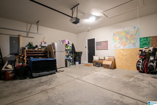  - garage with electric panel, freestanding refrigerator, and a garage door opener