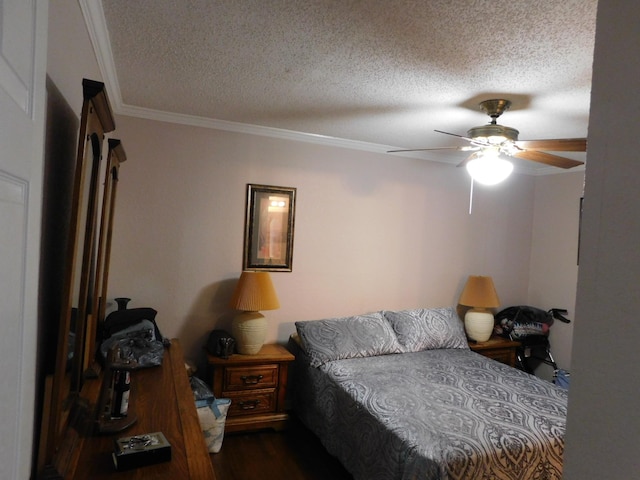 bedroom featuring ceiling fan, ornamental molding, a textured ceiling, and wood finished floors