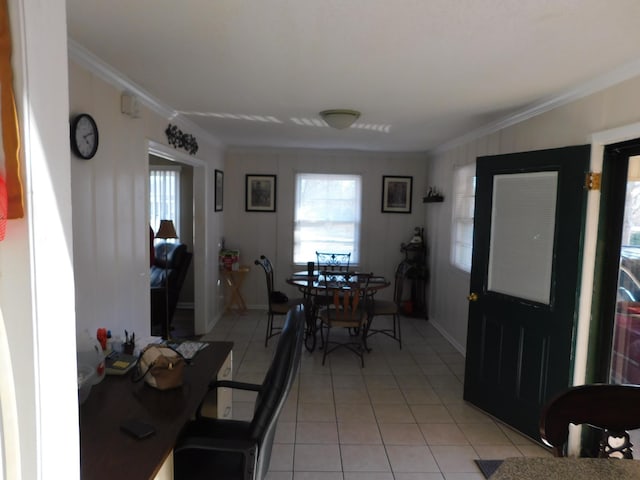 dining room with light tile patterned floors, baseboards, and crown molding