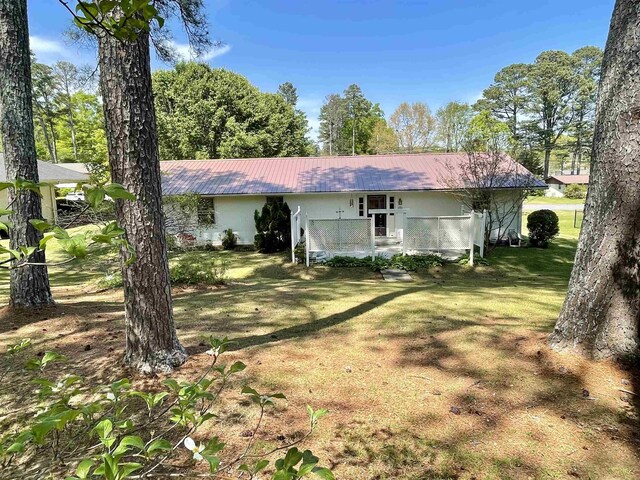  - view of front of property featuring a front lawn and metal roof