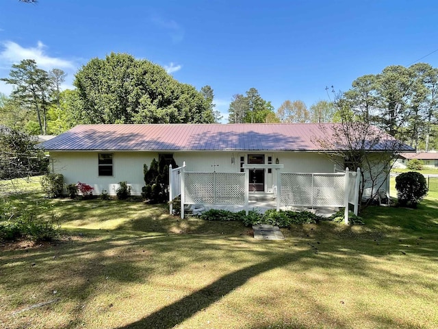  - back of property with a lawn and metal roof