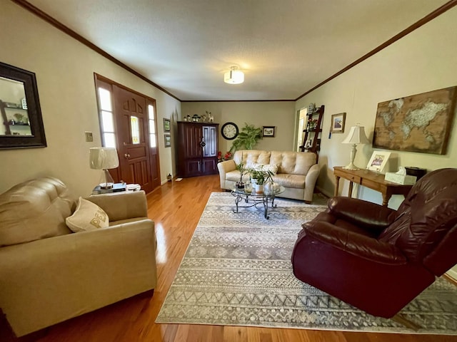  - living area featuring crown molding, wood finished floors, and baseboards