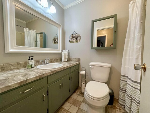  - bathroom with ornamental molding, vanity, and toilet