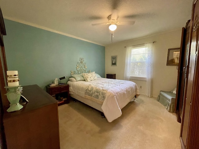  - bedroom with light colored carpet, crown molding, and ceiling fan