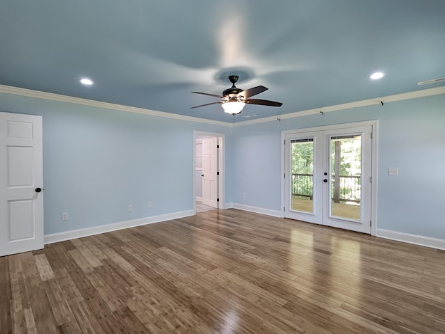 spare room featuring hardwood / wood-style floors, ceiling fan, crown molding, and french doors