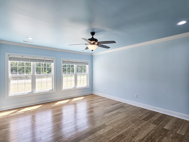 unfurnished room featuring hardwood / wood-style flooring, ceiling fan, and crown molding