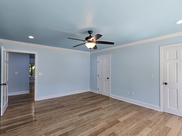 empty room with hardwood / wood-style floors, ceiling fan, and crown molding