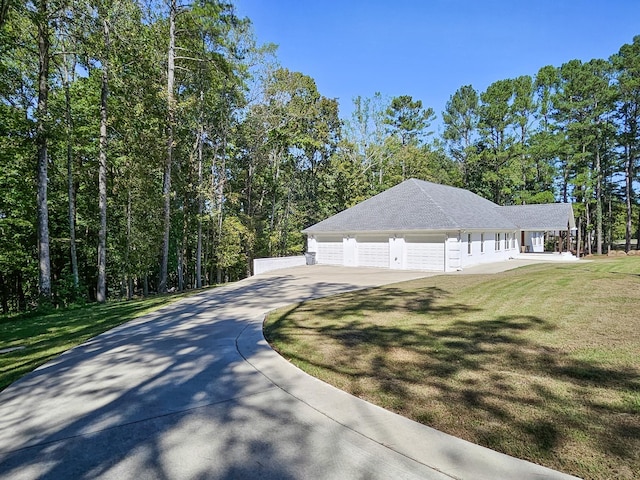 view of front of property featuring a garage and a front lawn