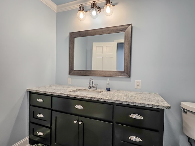 bathroom featuring vanity, toilet, and ornamental molding