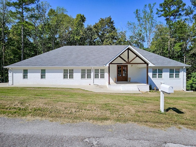 view of front of house featuring french doors and a front lawn