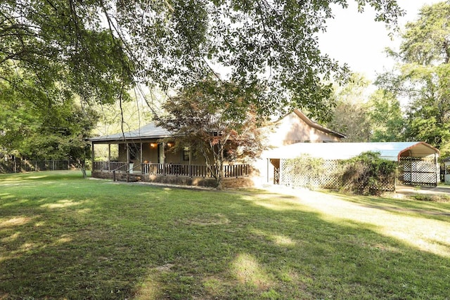 view of front of home with covered porch, a front lawn, and a carport