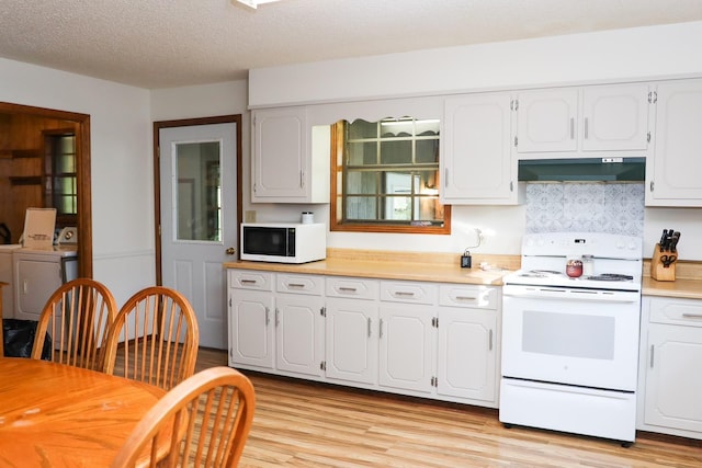 kitchen featuring white cabinets, light hardwood / wood-style floors, white appliances, and a textured ceiling