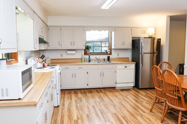 kitchen with light hardwood / wood-style floors, white cabinetry, white appliances, and sink