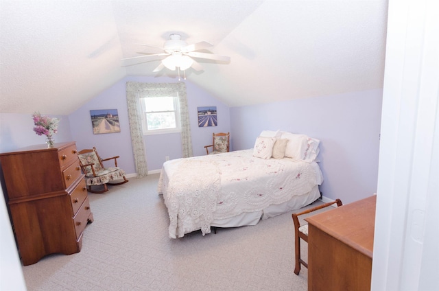 bedroom with light colored carpet, ceiling fan, and lofted ceiling