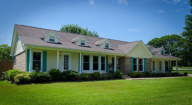 cape cod house with a front lawn