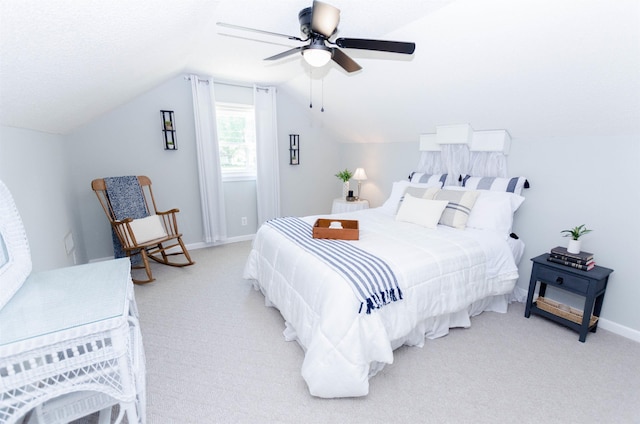 bedroom with ceiling fan, light carpet, and vaulted ceiling