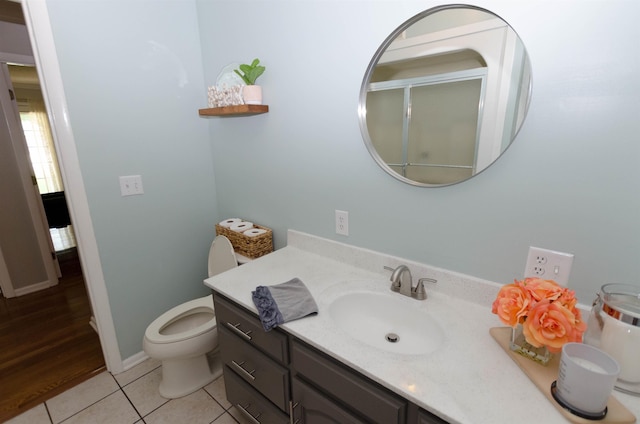 bathroom with tile patterned flooring, vanity, and toilet