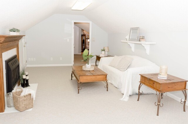 sitting room with carpet flooring, heating unit, and lofted ceiling